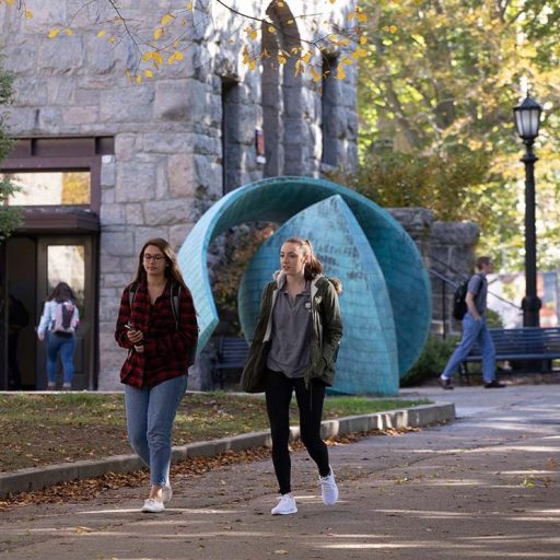 Two female students walking on campus