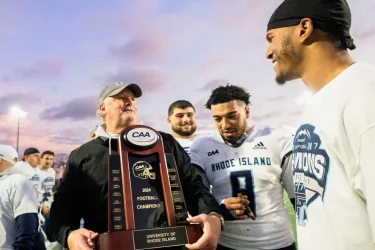 URI Football Coach Fleming with trophy